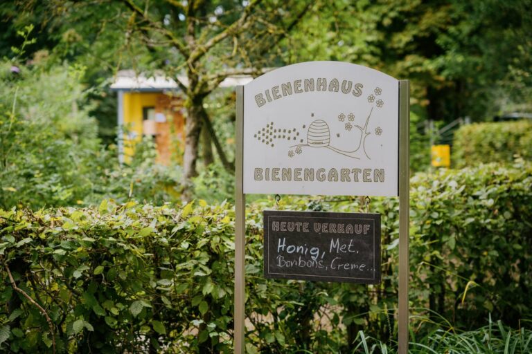 Ein Schild was zum Bienengarten führt.